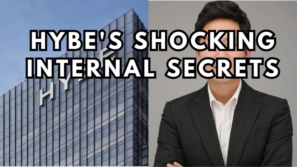 This contain an image Lee Jae Sang wearing glasses standing in front of a the hybe logo is on top of a building